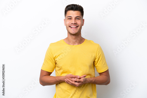 Young caucasian man isolated on white background laughing © luismolinero