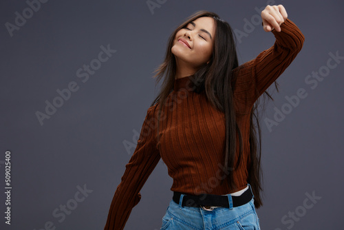 pretty woman fun brown sweater posing casual wear Gray background