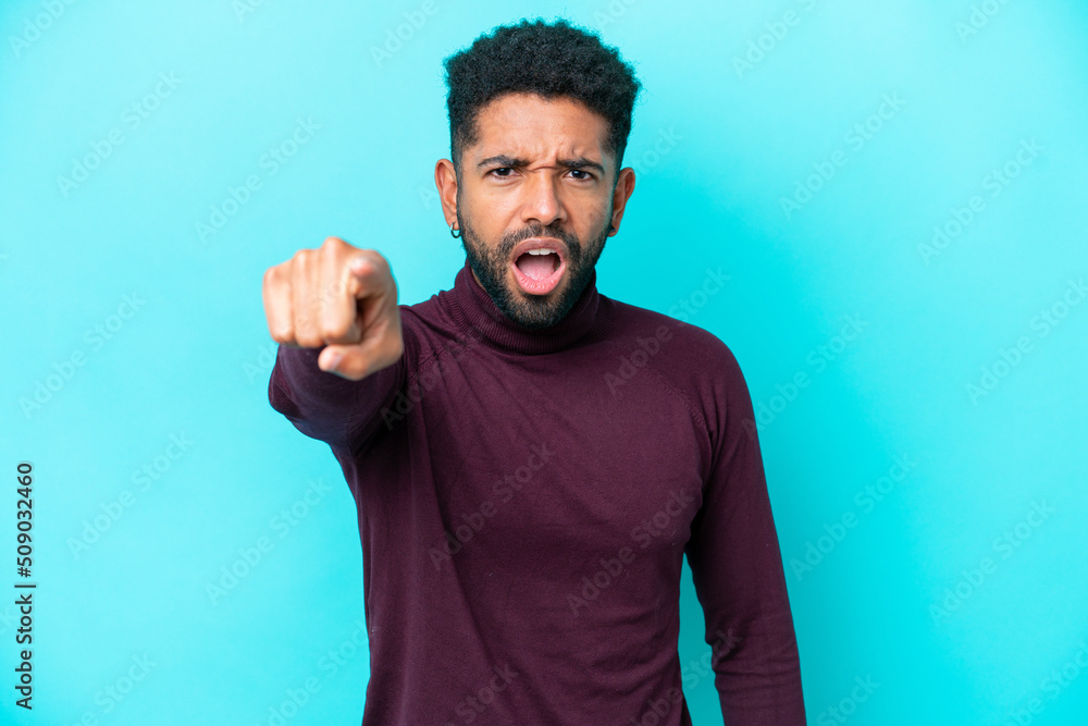 Fototapeta premium Young Brazilian man isolated on blue background frustrated and pointing to the front