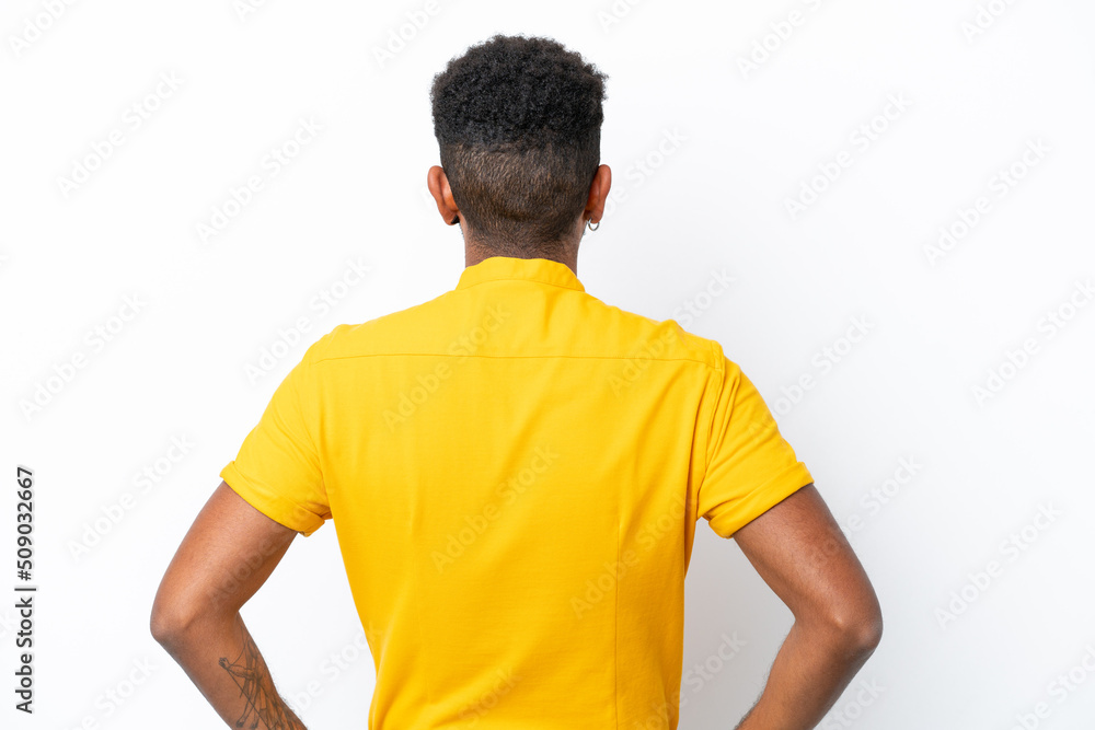 Young Brazilian man isolated on white background in back position Young Brazilian man isolated on white background in back position