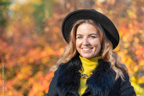 beautiful girl white toothed smile, young happy woman whitened teeth in hat in autumn in park. portrait of stylish smiling lady in yellow clothes. fashion female fall with red leaves outdoors © Елена Якимова