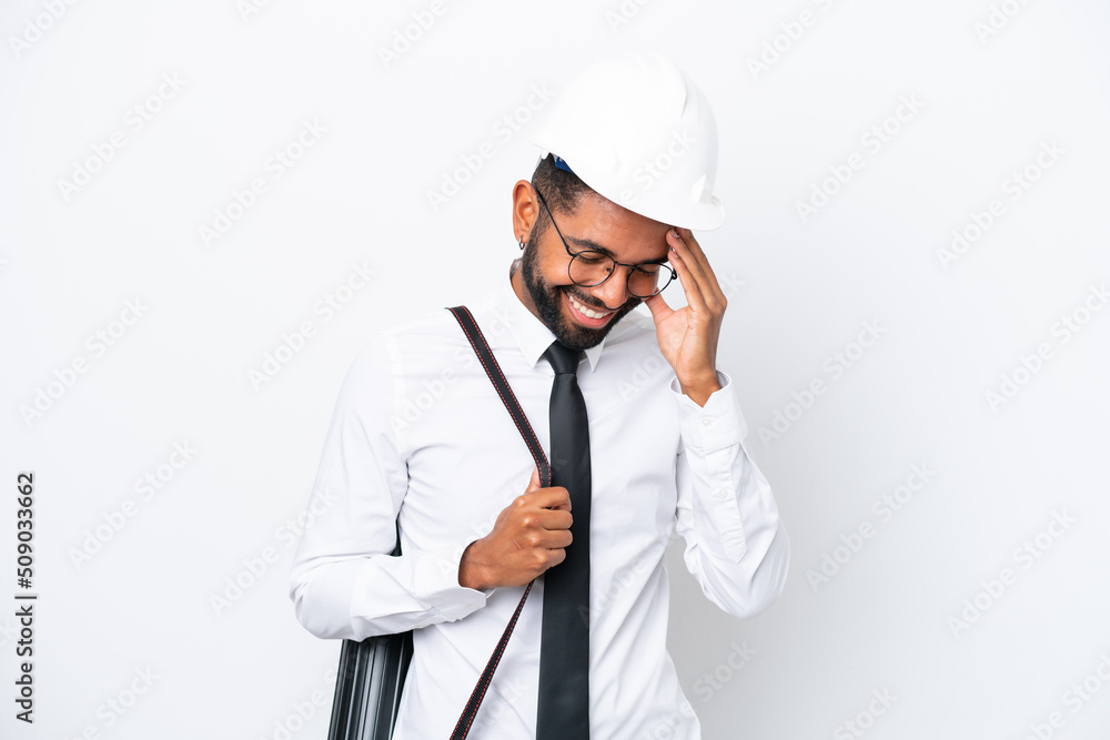 Young architect Brazilian man with helmet and holding blueprints isolated on white background laughing Young architect Brazilian man with helmet and holding blueprints isolated on white background laughing