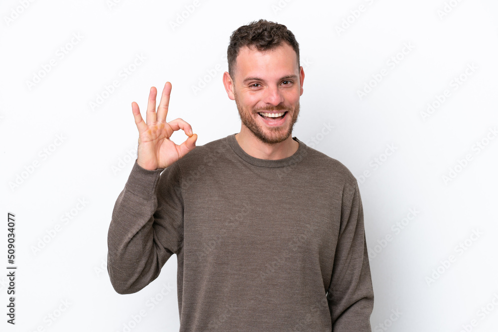 Young Brazilian man isolated on white background showing ok sign with fingers Young Brazilian man isolated on white background showing ok sign with fingers
