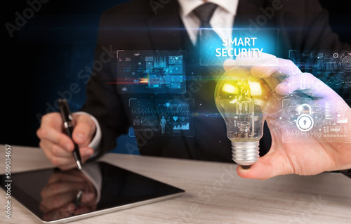 Businessman holding a light bulb, online security concept