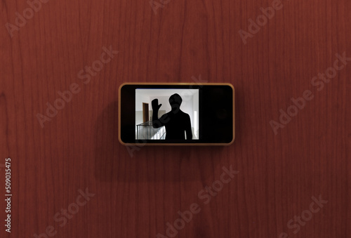 Monitor digital peephole watching a stranger outside the door photo