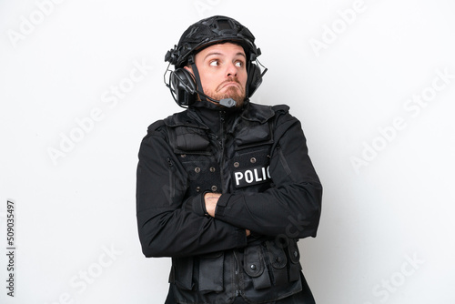 Brazilian soldier man isolated on white background making doubts gesture while lifting the shoulders