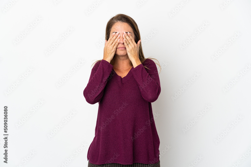 Middle age Brazilian woman isolated on white background covering eyes by hands Middle age Brazilian woman isolated on white background covering eyes by hands