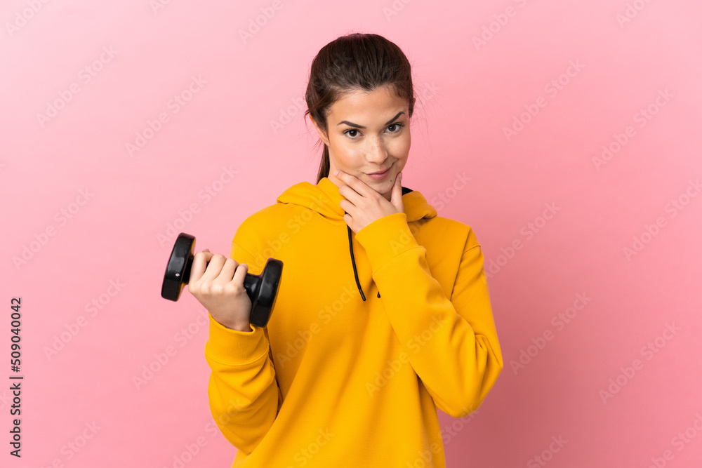 Young sport girl making weightlifting over isolated pink background thinking Young sport girl making weightlifting over isolated pink background thinking