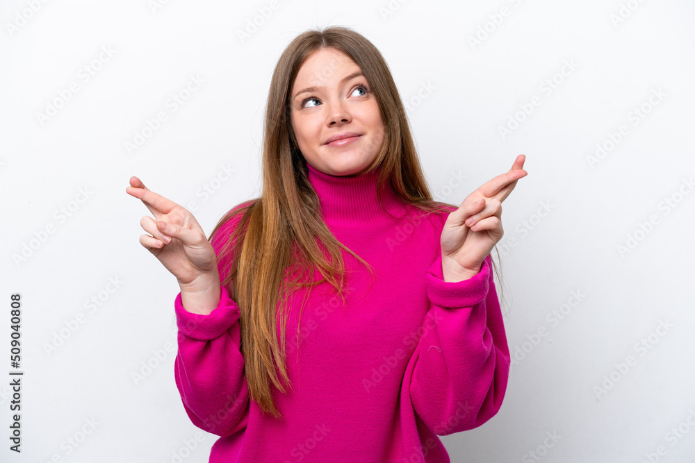 Young caucasian woman isolated on white background with fingers crossing and wishing the best Young caucasian woman isolated on white background with fingers crossing and wishing the best