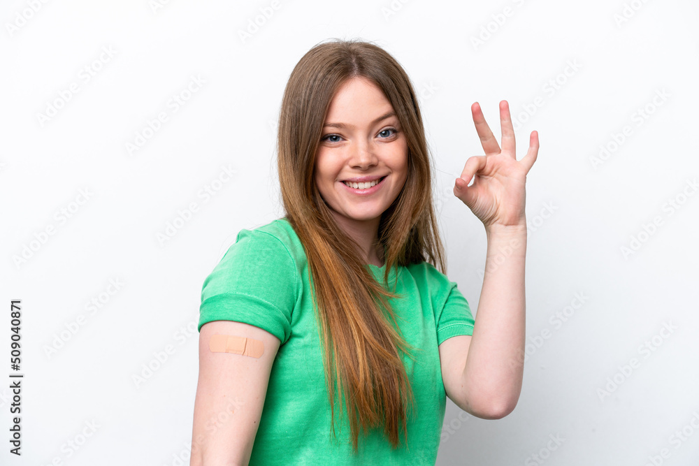 Young caucasian woman wearing a band aids isolated on white background showing ok sign with fingers Young caucasian woman wearing a band aids isolated on white background showing ok sign with fingers