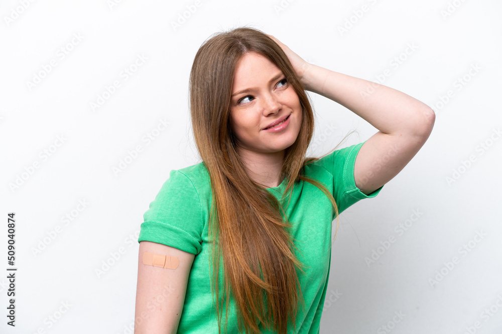 Young caucasian woman wearing a band aids isolated on white background having doubts and with confuse face expression Young caucasian woman wearing a band aids isolated on white background having doubts and with confuse face expression