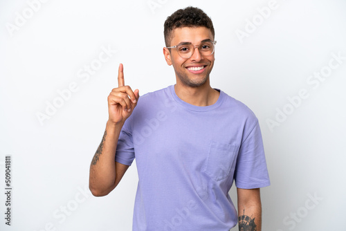 Young caucasian Brazilian man isolated on white background showing and lifting a finger in sign of the best