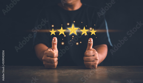 Customer experience satisfaction concept. Hand of client thumb up positive emotion smile face icon and five star. Standardization and quality in products and services. Excellent services rating. photo