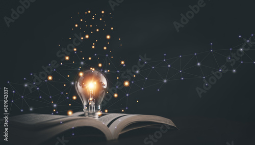 Glowing light bulb on a book, Inspiring from read concept, Educational knowledge and business education ideas, Innovations, self-learning, knowledge and searching for new ideas. Thinking for new idea.