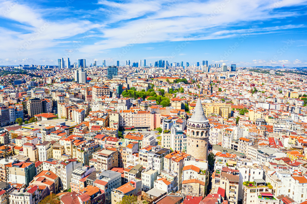 Aerial drone view of Galata Tower and business district in Istanbul, Turkey. Summer sunny day