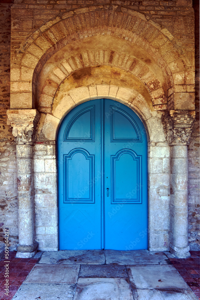 Stone portal and wooden door from a medieval church in Champagne