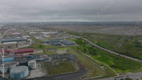 Aerial panoramic footage of flat coastal landscape. Industrial site and residential borough of large town. Port Elisabeth, South Africa