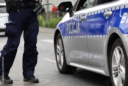 Radiowóz polskiej policji w mieście podczas patrolu na sygnale alarmowym. 