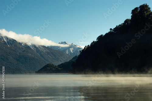 Obraz na płótnie Lake evaporating in the morning with a snowy mountain range in the background. Rivadavia Lake, Los Alerces National Park w salonie