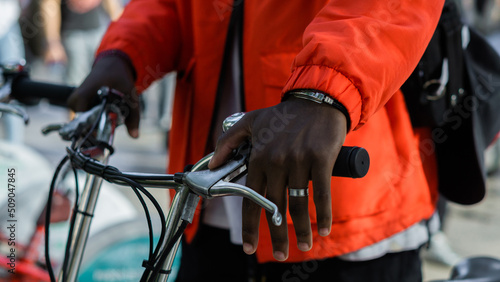 Detail of the hands of an unrecognizable person using a bicycle in the city. 
