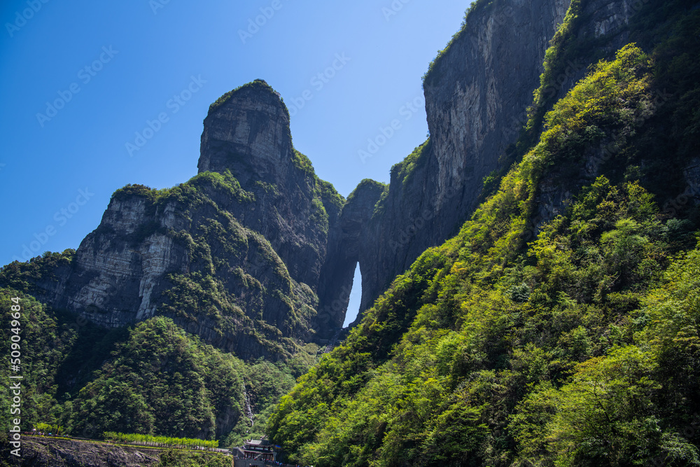 Tianmen cave covered with green forest in Zhangjiajie, Hunan, China, horizontal background shot, copy space for text
