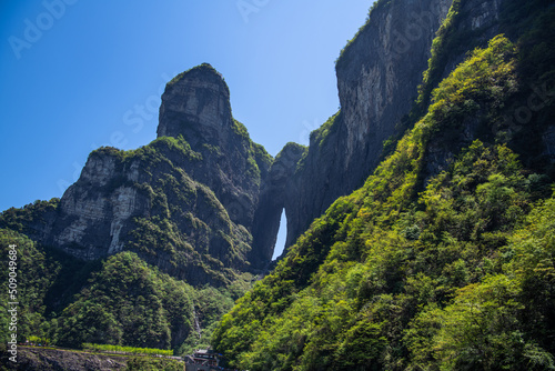 Tianmen cave covered with green forest in Zhangjiajie, Hunan, China, horizontal background shot, copy space for text © Tatiana Kashko