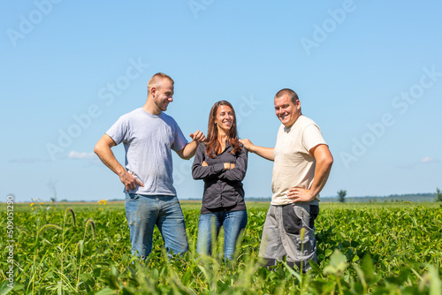Young modern farming entrepreneurs in a soy field. High quality photo