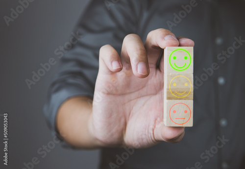 Customer review good rating concept, customer review by smiley face icon feedback on smartphone, positive customer feedback testimonial.