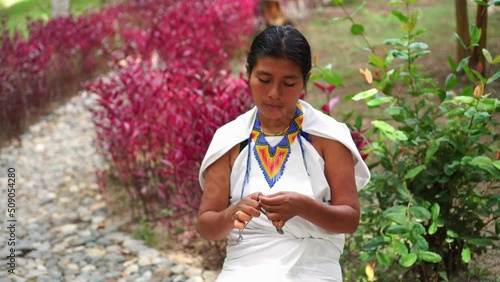 Indigenous woman from the Sierra Nevada of Colombia making traditional weavings photo