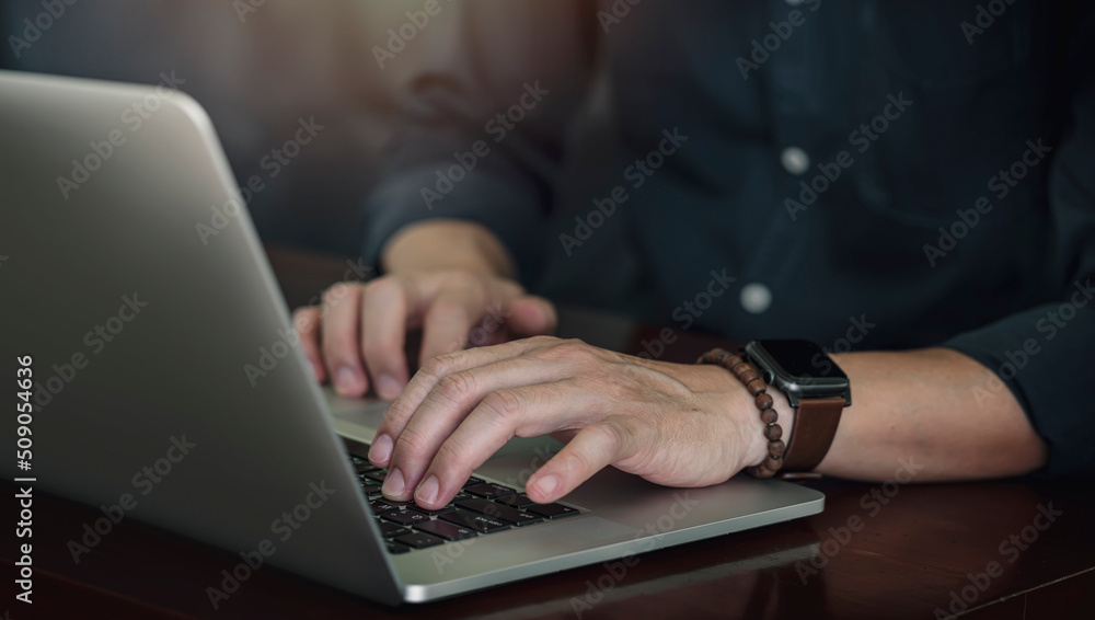 Cropped shot of man hand working on laptop computer. Cropped shot of man hand working on laptop computer.