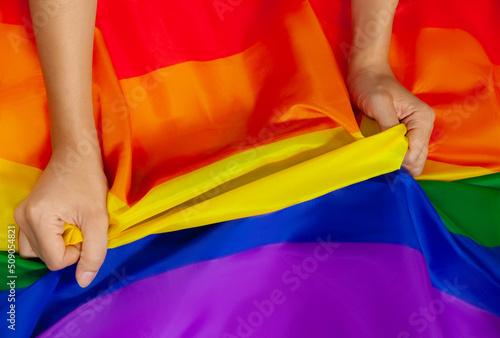 Pride flag LGBTQ and lgbtq+ flag and hand symbol of Lesbian Gay Bi sexsual Transgender Queer or homosexsual pride Rainbow flag. Represent hands symbol of freedom equality. photo