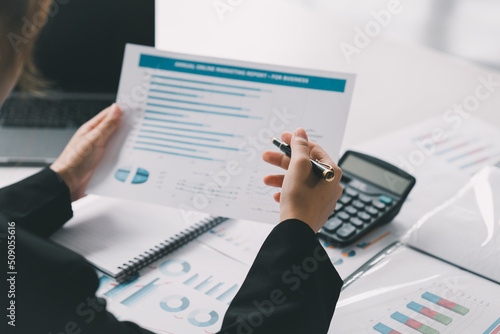 Woman investment consultant analyzing company annual financial report balance sheet statement working with documents graphs. Stock market. financial and investment concept.