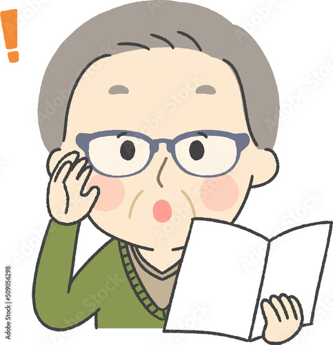 メガネをかけて本を読むシニア男性