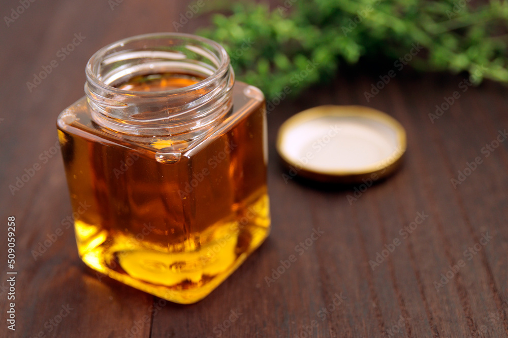 Honey in a cosmetological jar on the table Honey in a cosmetological jar on the table