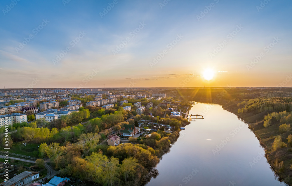 Beauriful sunset view along the Iset river and rocks in town Kamensk-Uralskiy. A scenic sunset at the river. Kamensk-Uralskiy, Sverdlovsk region, Ural mountains, Russia. Aerial view