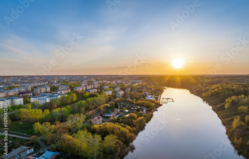 Beauriful sunset view along the Iset river and rocks in town Kamensk-Uralskiy. A scenic sunset at the river. Kamensk-Uralskiy, Sverdlovsk region, Ural mountains, Russia. Aerial view