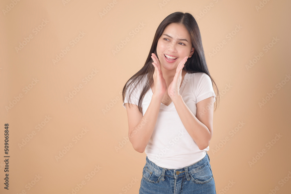 A Portrait of Asian woman with white T-shirt over Light brown background studio A Portrait of Asian woman with white T-shirt over Light brown background studio