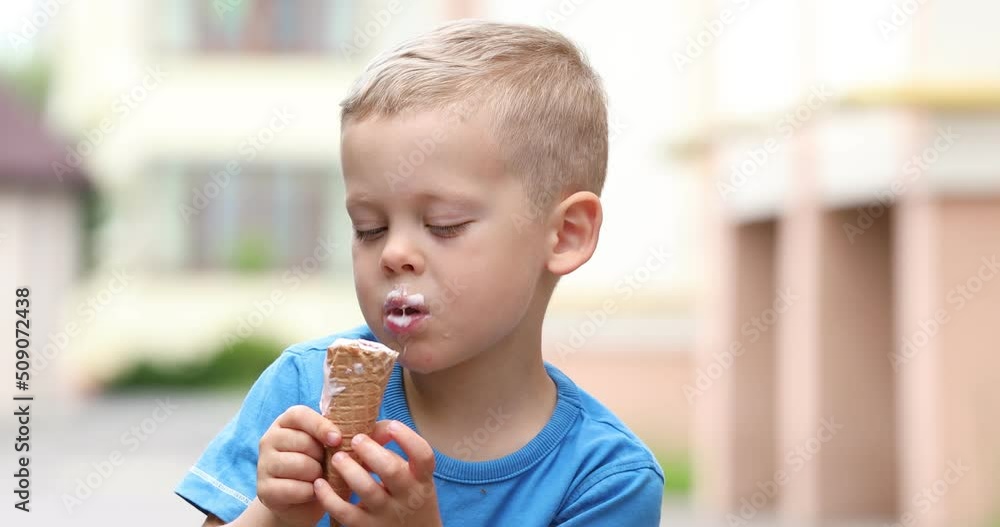 little boy eating ice cream on the street little boy eating ice cream on the street
