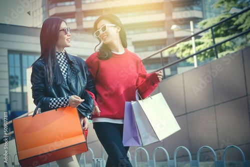 Happy girlfriends go shopping shopping