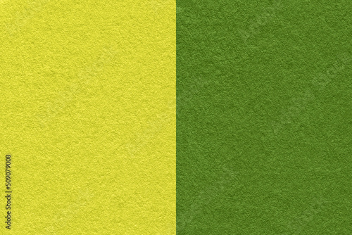 Texture of craft green and dark olive paper background, half two colors, macro. Structure of vintage lime cardboard.