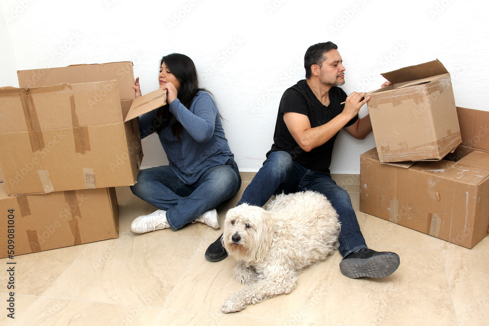Fototapeta premium Couple of Latin man and woman move house thanks to a real estate agency they are happy for the beginning of a new life together and create a family 