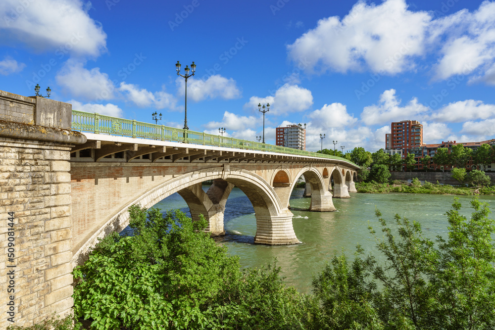 Bridge spans over a river in a city in springtime. Pont des Catalans, Toulouse, France