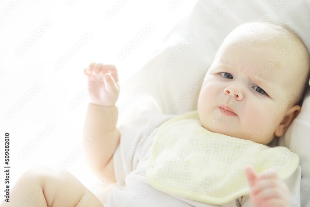 Maternity concept. A young mother feeds her little baby. First lure and breastfeeding. Family in white clothes. Maternity concept. A young mother feeds her little baby. First lure and breastfeeding. Family in white clothes.