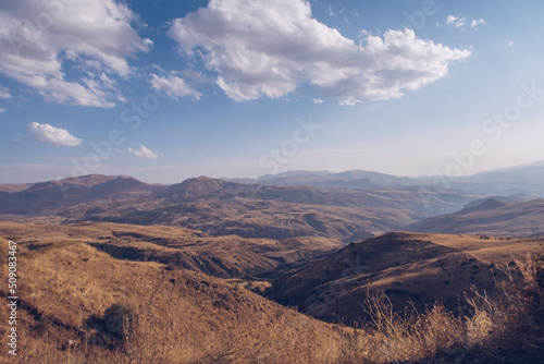Picturesque Armenian autumn landscape in the backgrounds. Fields and meadows in the mountains of Armenia region. Marvellous blue sky and clouds. Stock photography