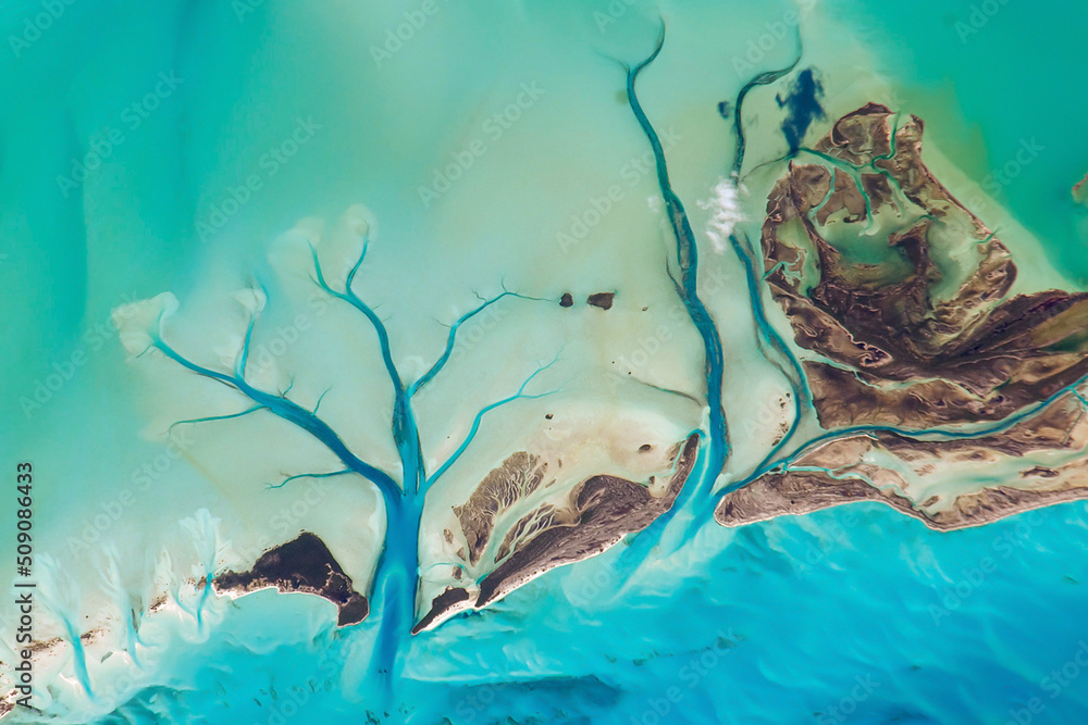 Aerial view of the Bahamas islands, Turquoise ocean surface, Tidal Flats and Channels, Long Island, the Bahamas, Sandy Cay. Top view of Caribbean sea texture. Elements of this image furnished by NASA. - obrazy, fototapety, plakaty 
