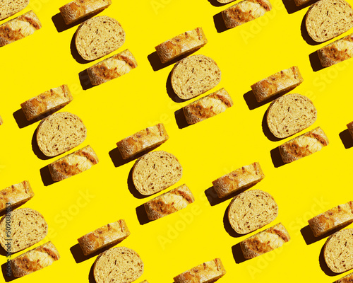 Top view of sliced bread on a yellow background. Food pattern