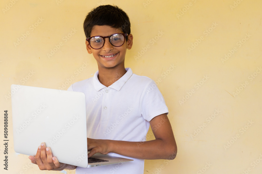 happy Indian kid using laptop concept of online class learning. Stock ...
