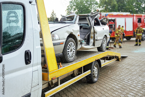 Wrecked car loading on tow truck after crash traffic accident, Concept of dangerous driving after drinking alcohol, Roadside assistance concept