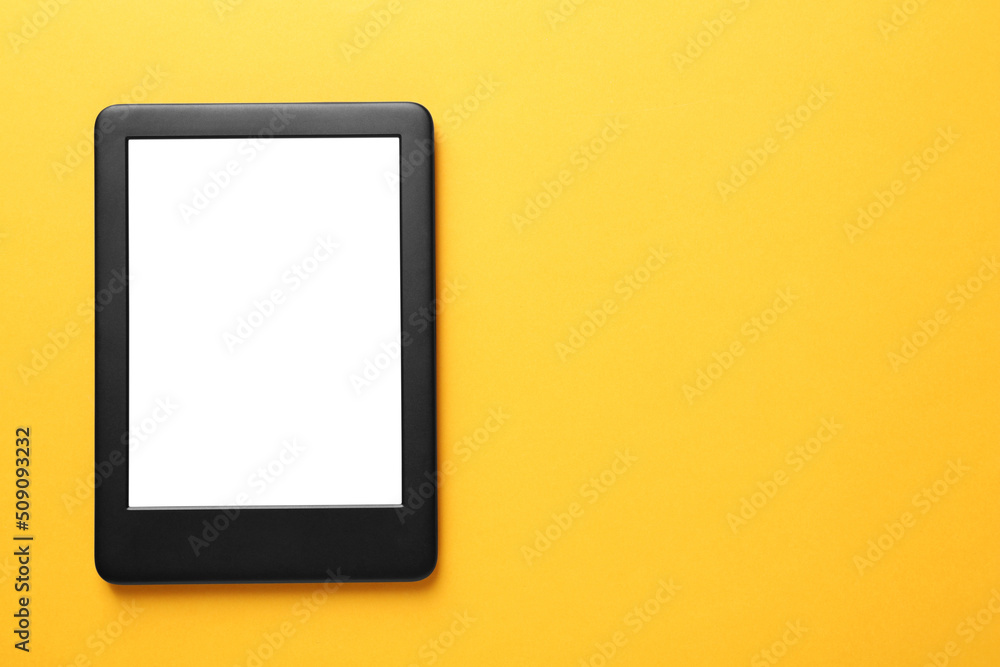 Modern e-book reader with blank screen on orange background, top view. Space for text Modern e-book reader with blank screen on orange background, top view. Space for text