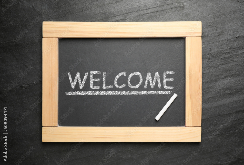 Blackboard with word WELCOME and chalk on slate background, top view Blackboard with word WELCOME and chalk on slate background, top view